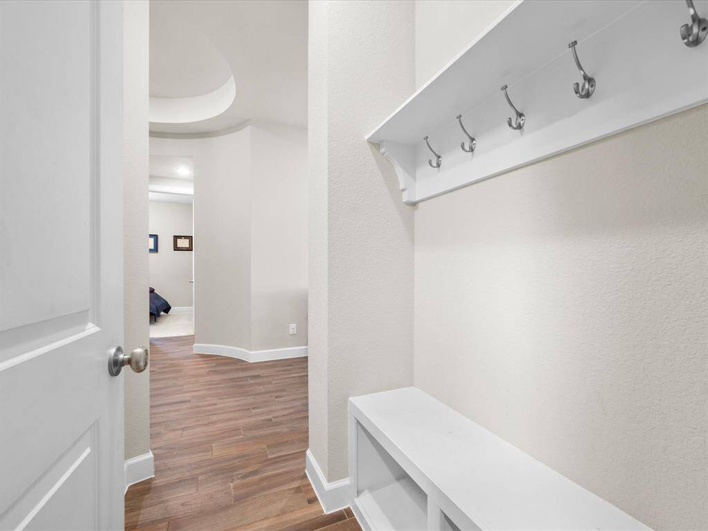 Convenient mudroom set up just off the garage, perfect for storing shoes, coats, and outdoor gear. This functional space offers a practical and organized area for daily use, keeping the home tidy and clutter-free.