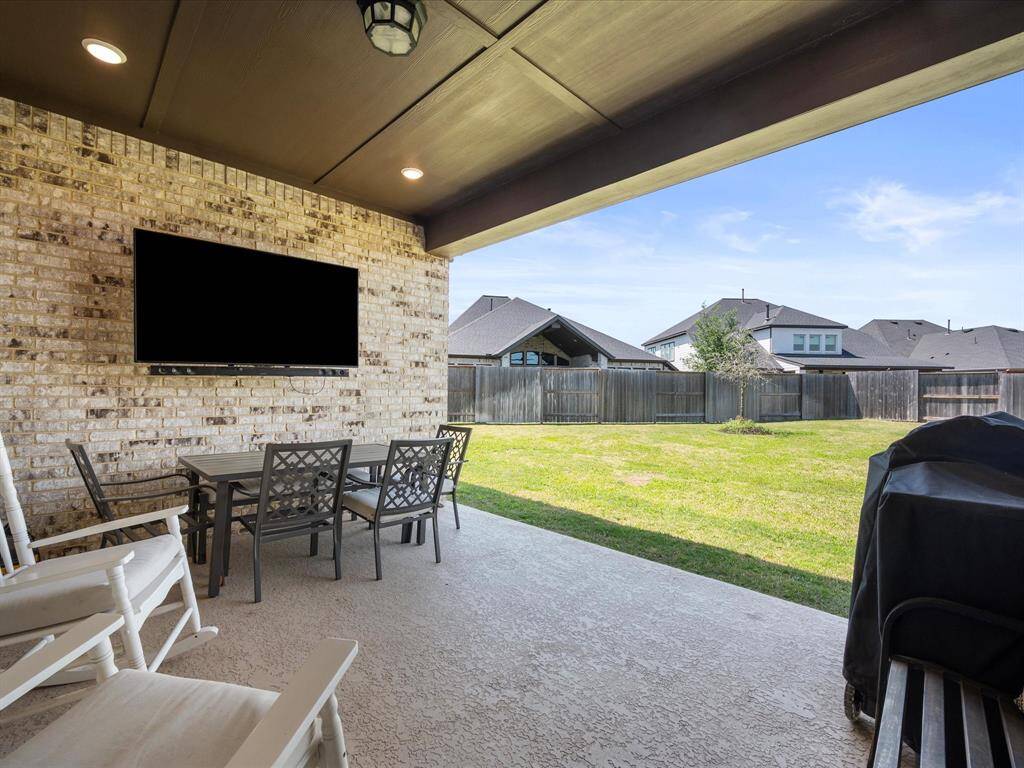 Expansive, brick-covered patio located right off the living area, offering plenty of room for outdoor furniture and entertaining. This inviting space is perfect for relaxing or hosting guests, providing a seamless transition between indoor and outdoor living.