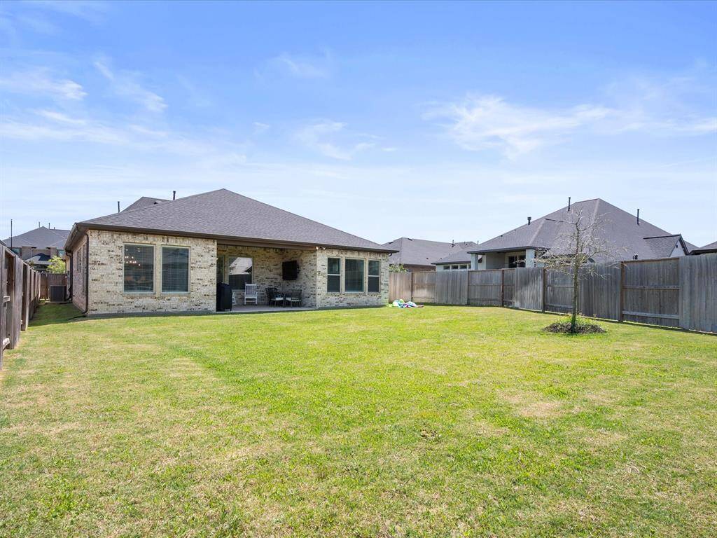 Spacious, fully fenced backyard offering plenty of privacy and a vast expanse of green space. Perfect for outdoor activities and/or gardening.