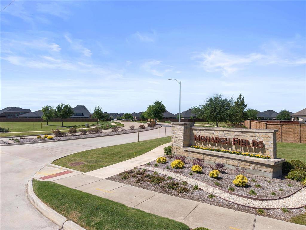 Welcoming view of the entrance to Monarch Fields section showcasing the charming curb appeal and inviting atmosphere.