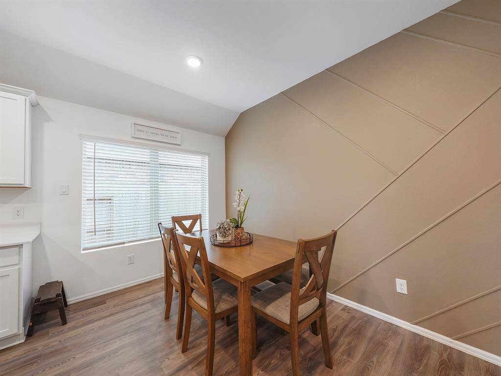 Experience elegance in the dining area, featuring a beautifully decorated custom accent wall that adds charm and character.
