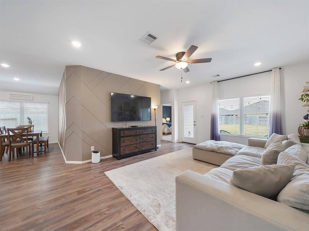 With abundant natural light pouring in through large windows, the room feels bright and airy. The generous layout offers plenty of space for a comfortable sofa set and coffee table.