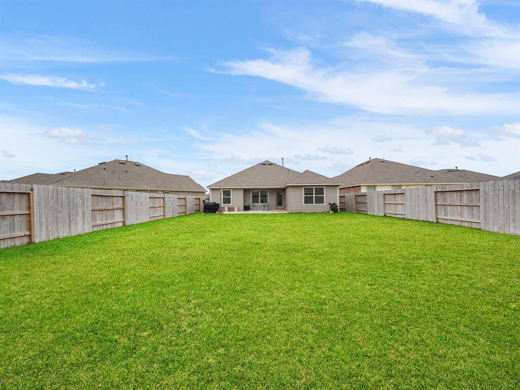 Backyard has ample space for outdoor activities.