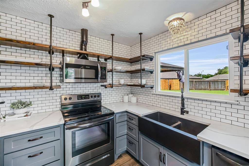 The deep, double farm house sink that affords a view to the backyard will make washing dishes a pleasure!