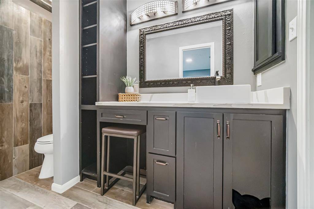 The primary bathroom is a spa-like retreat with vanity space, ample storage, and a walk-in shower.