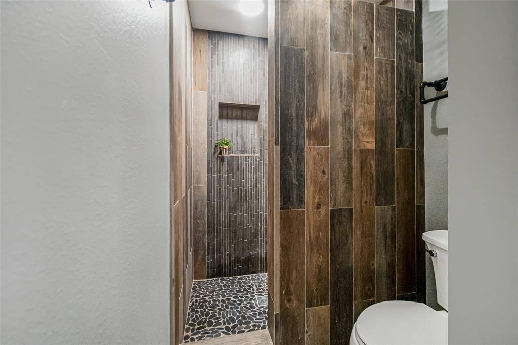 The open, walk-in shower features beautiful tile and offers refreshing and relaxing showers.  A bonus: there's no glass to clean!