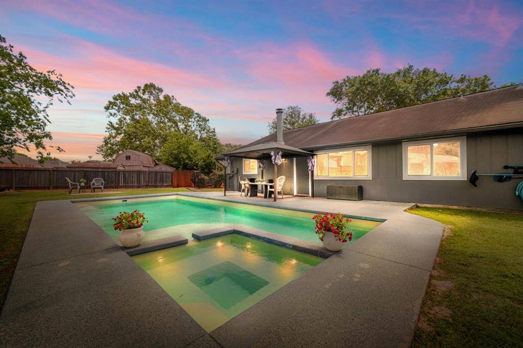 A peek at the backyard shows an amazing pool and spa.