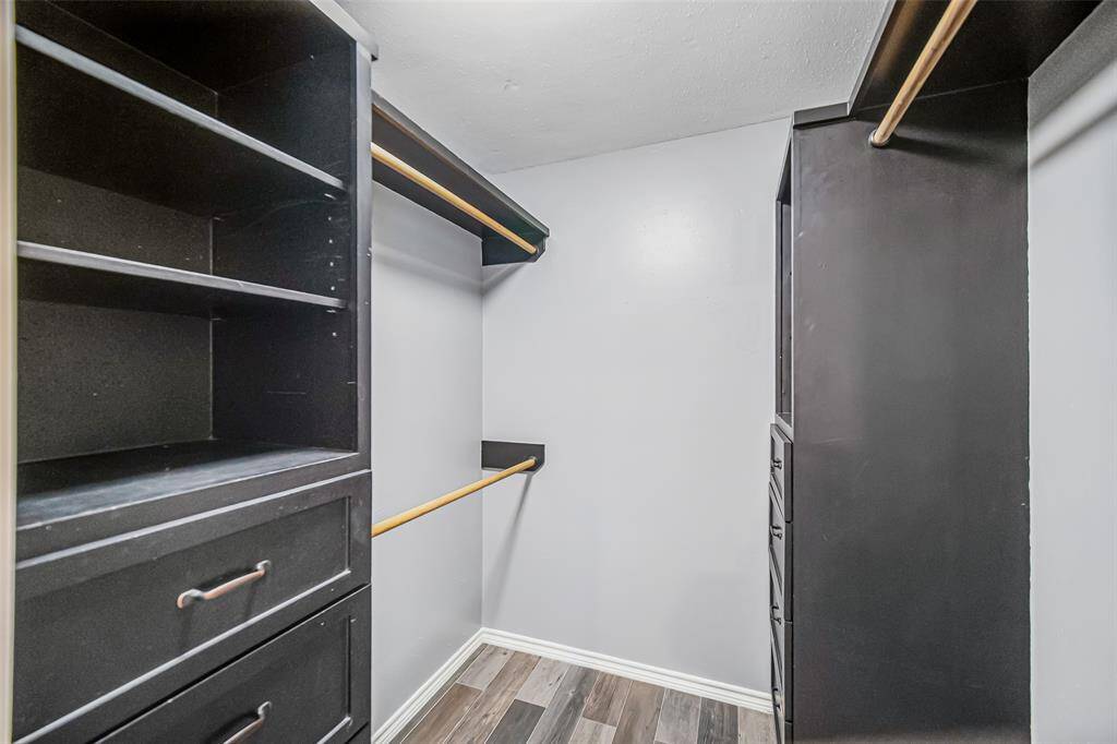 The primary bedroom's walk-in closet includes shelves and drawers providing ample and practical storage space.