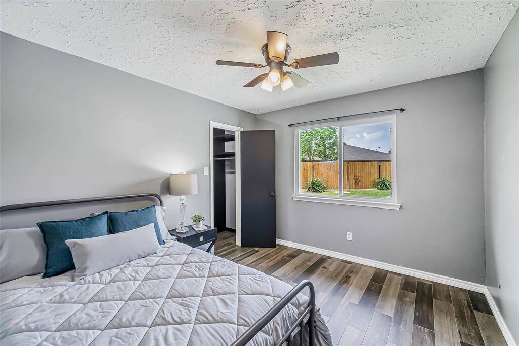 This second of three bedrooms is spacious and features a large window.