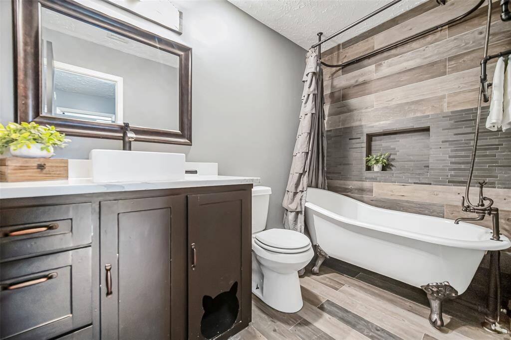 The second and third bedrooms share this hall bathroom that has been remodeled with custom cabinetry and a clawfoot tub/shower.