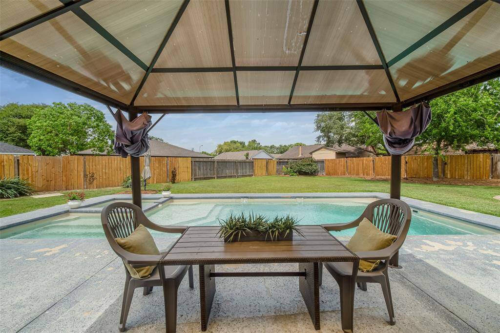 Outside, the pergola adds to the comfort and charm of this outdoor space.