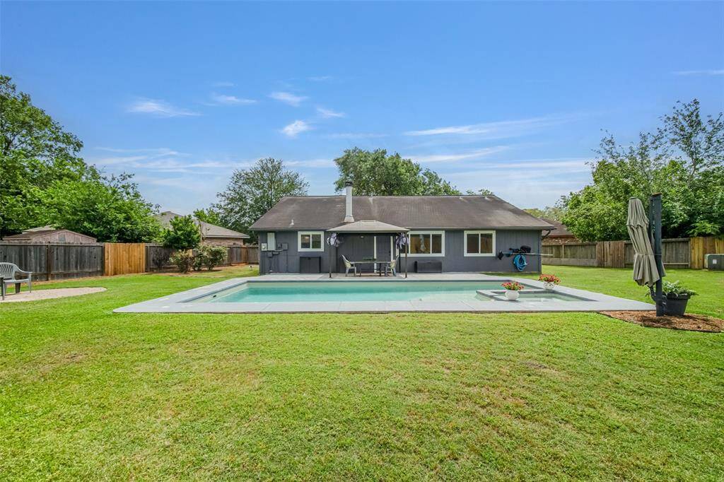 This backyard is truly an outdoor oasis! You will want to grab a float, jump in the pool, and relax!