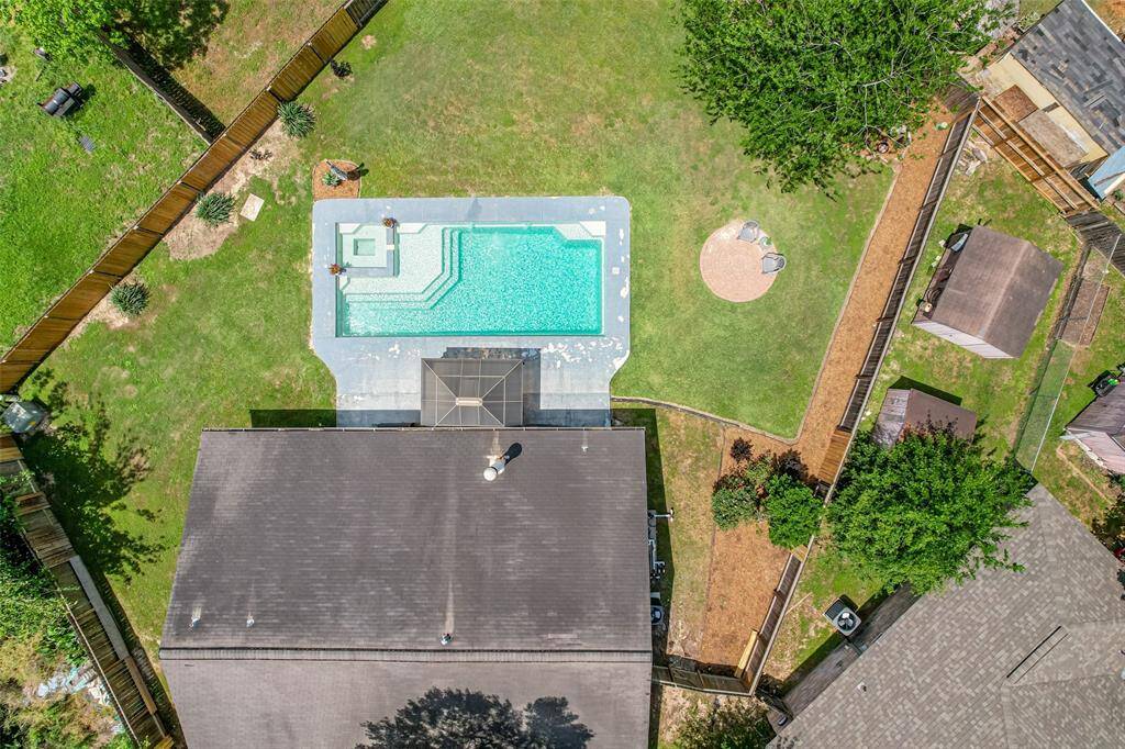 An aerial view of the pool and backyard shows ample space for outdoor entertaining!