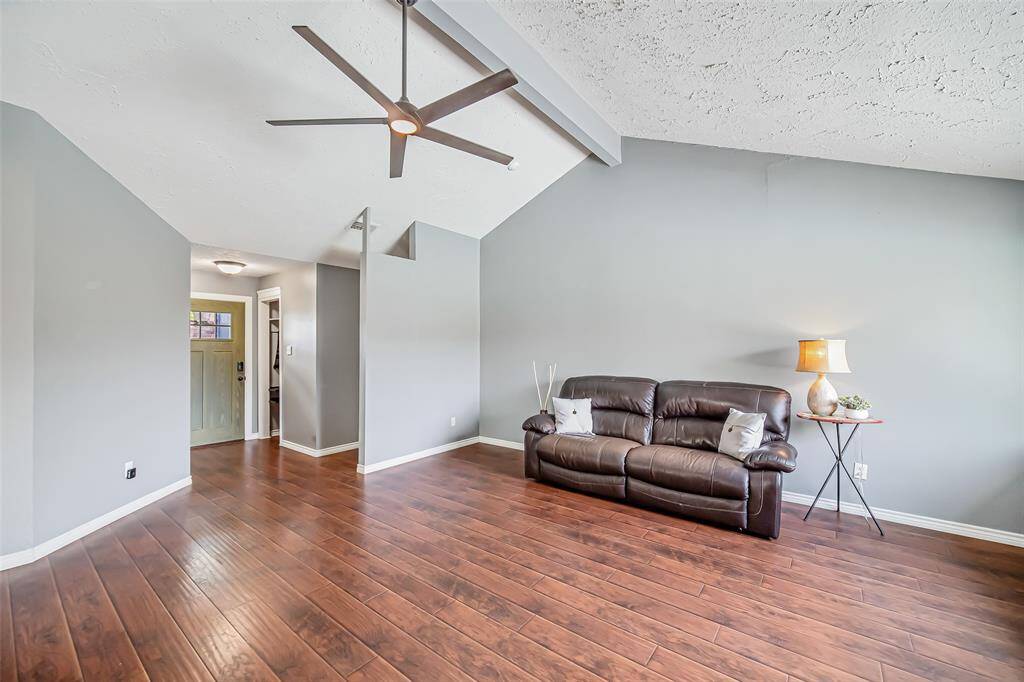 Here's a view back to the cozy entryway,  Note the vaulted ceiling in the family room, which brings so much height and a feeling of spaciousness to the room.