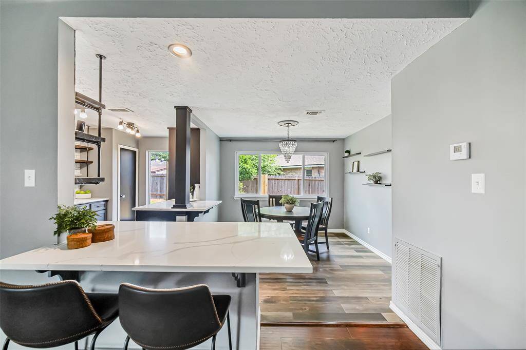 At the kitchen, the extended quartz countertop with room for two stools is a perfect breakfast bar.