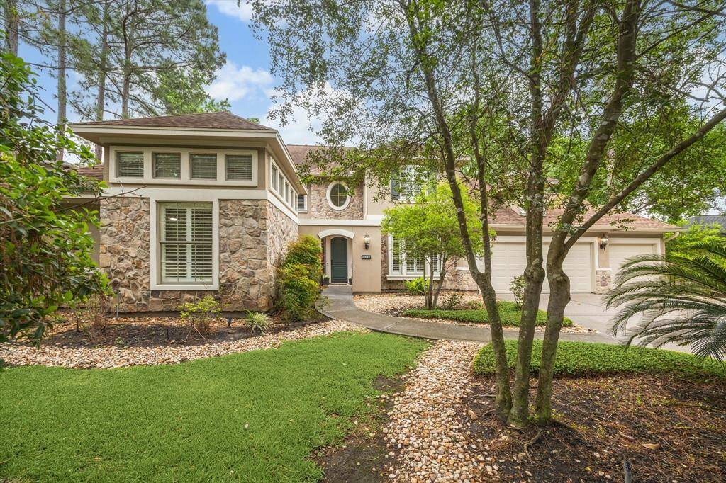 Nestled among mature trees in the highly sought-after Beckonvale community, this lovely five bedroom stucco and stone residence by Life Forms exudes timeless charm. A paved walkway leads from the driveway to a gated front courtyard, thoughtfully framed by lush landscaping.
