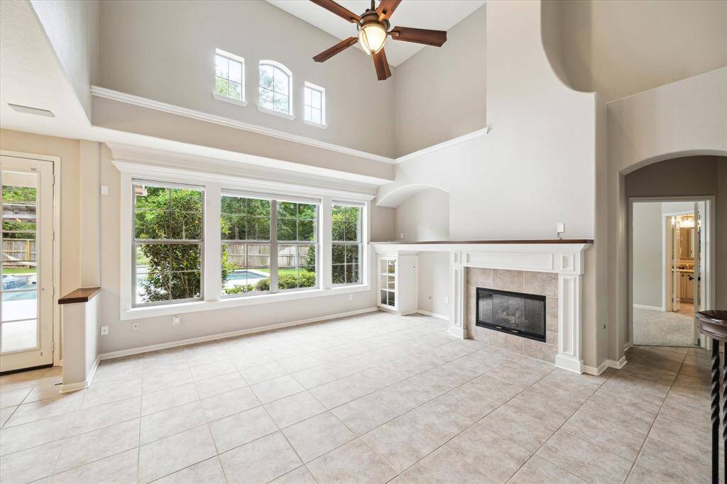 Another view showcasing the wall of windows that offer gorgeous views of the sparkling pool, spa, and backyard space.