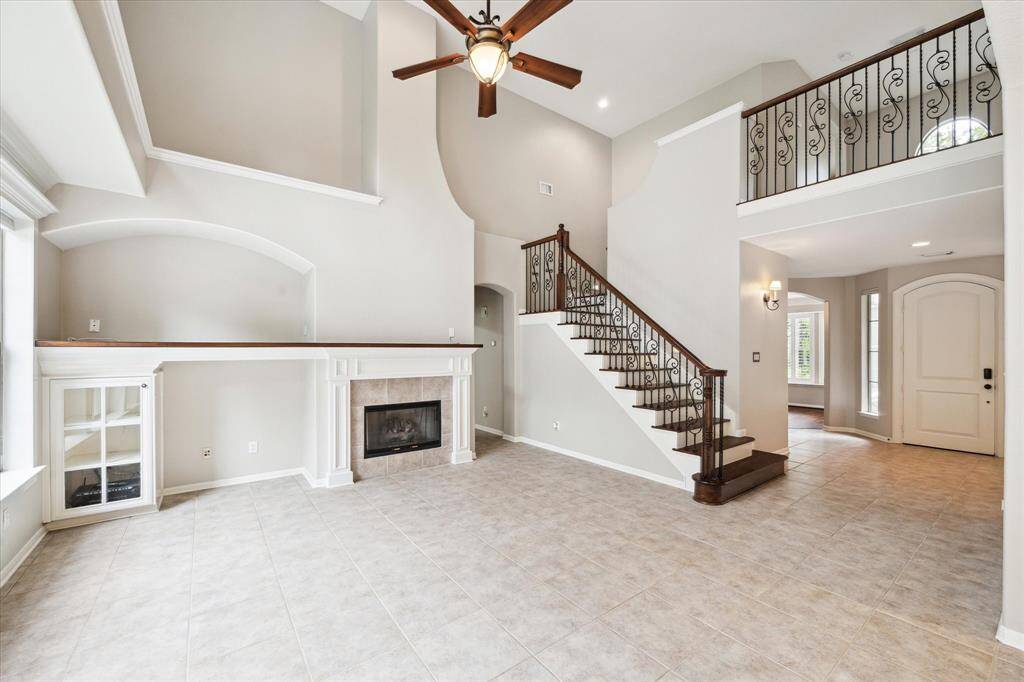 The open layout, combined with an abundance of windows, fills the home with natural light and creates an airy, inviting atmosphere. Throughout the interior, paint in a light designer color palette enhances the home's elegance.
