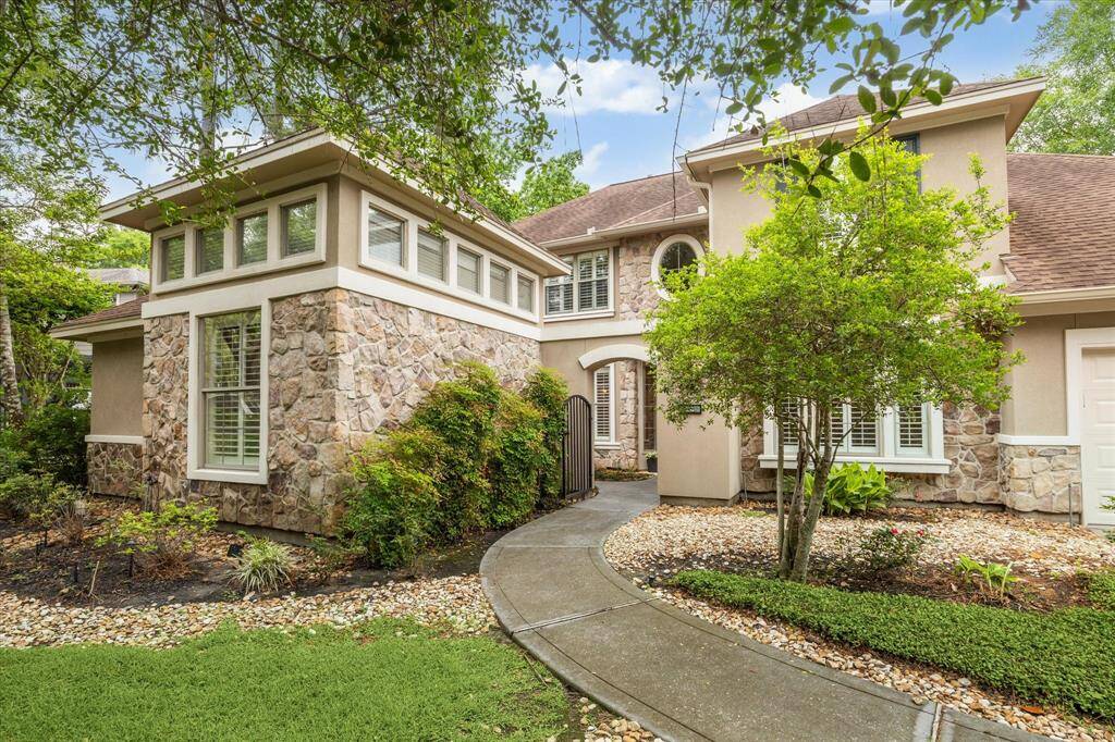 A welcoming courtyard invites you in as you step through the entryway, leading to a private, attached guest suite with its own separate access. The home also features a true three car garage and a charming front courtyard, complete with a wrought iron gate for added character and curb appeal.