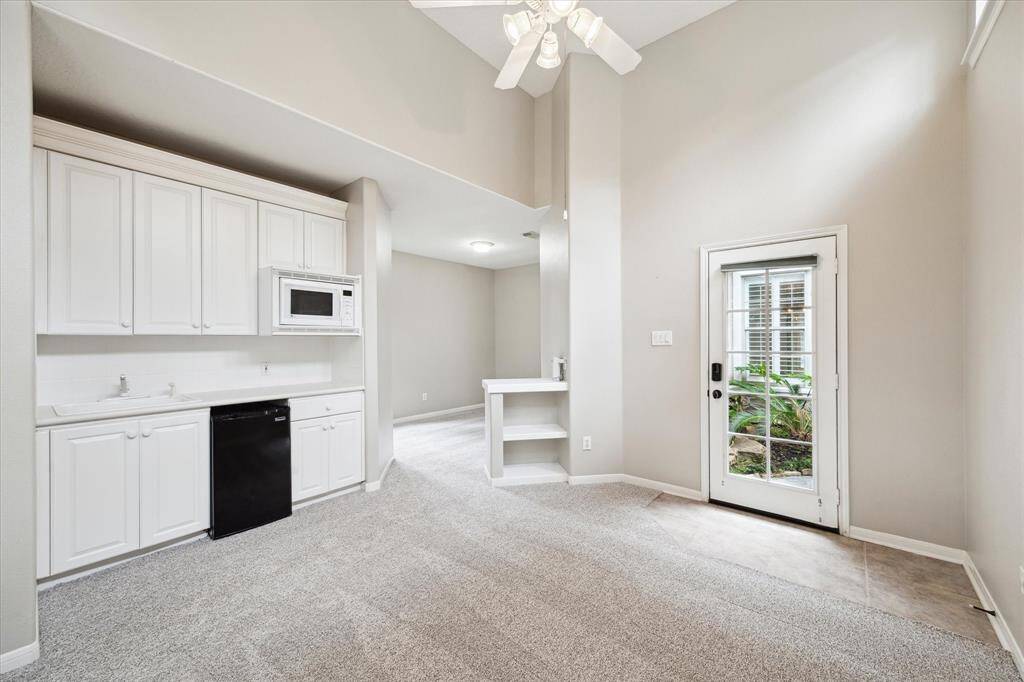 Another perspective of the first floor guest suite reveals its added conveniences, including a private kitchenette and a full bath featuring a walk-in glass enclosed shower.