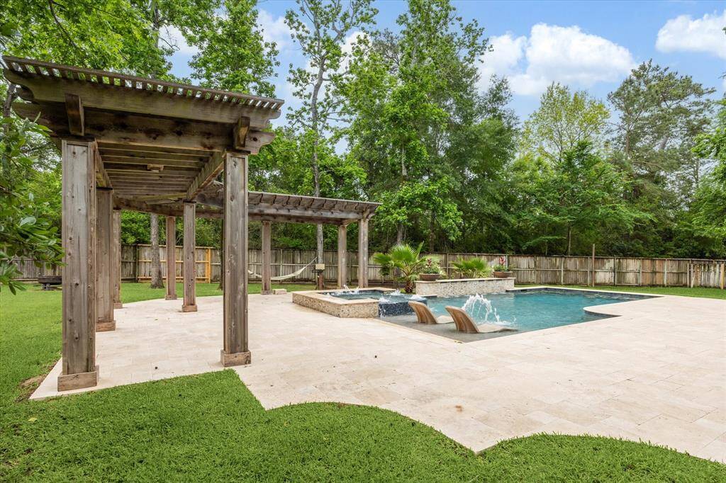 This is a lovely backyard oasis offering designated spaces for lounging, relaxing, and play!
