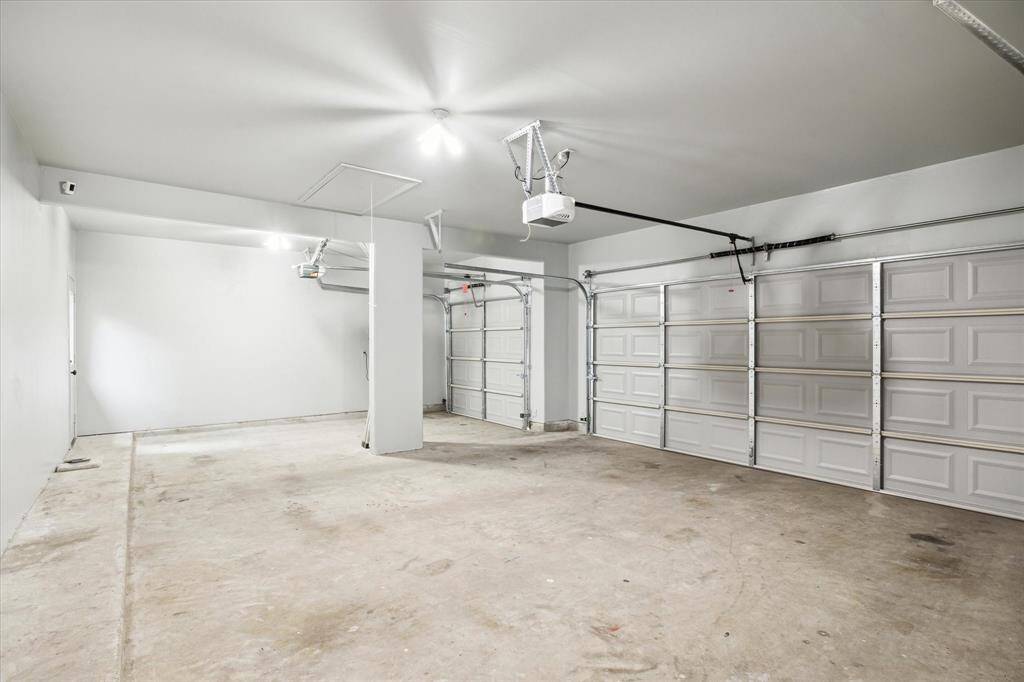 This spacious true three car garage offers ample room for vehicles, storage, or even a home workshop. Thoughfully designed, it includes a rear access door that opens directly to the backyard space.