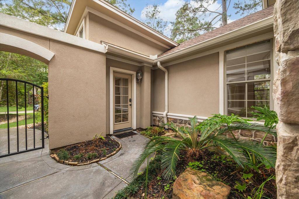 A glass french door provides private outdoor access to the attached guest suite, offering both convenience and a charming architectural detail.