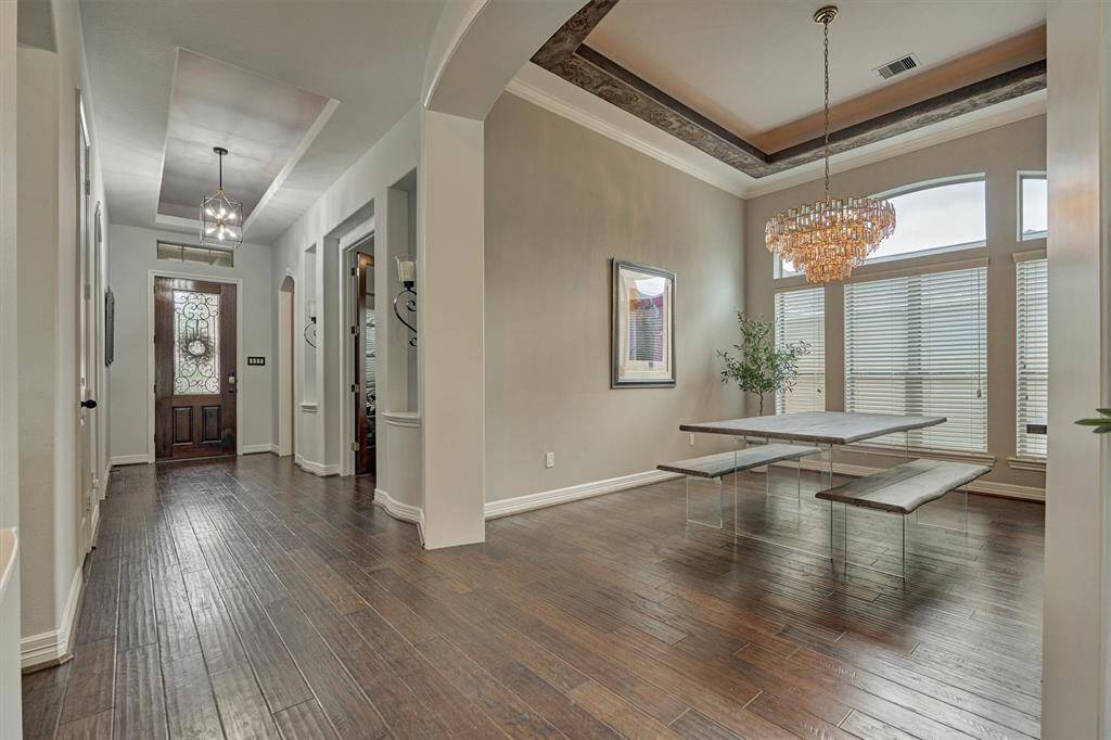 View of the dining room with uplighting and chandelier.