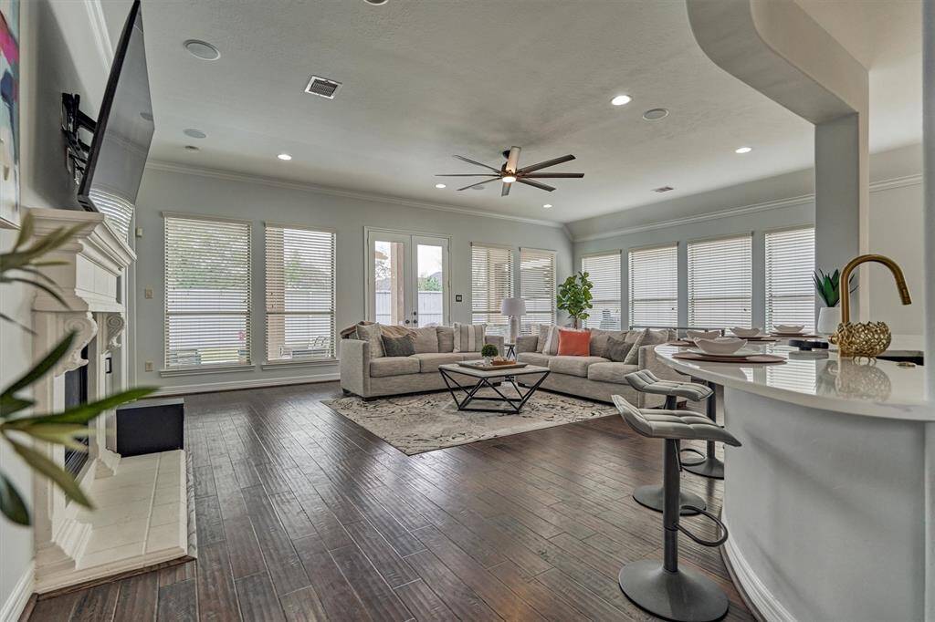 Open floor plan from the kitchen to the living room.  Wall of windows across the back and side of the home offer ample natural light.