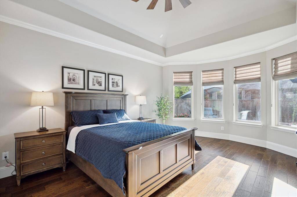 Main bedroom.  Ceiling detail, great windows and wood flooring.