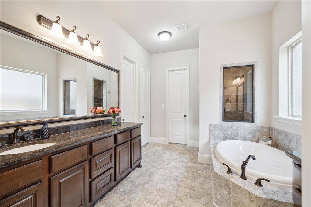 Main bathroom with soaking tub and separate shower.