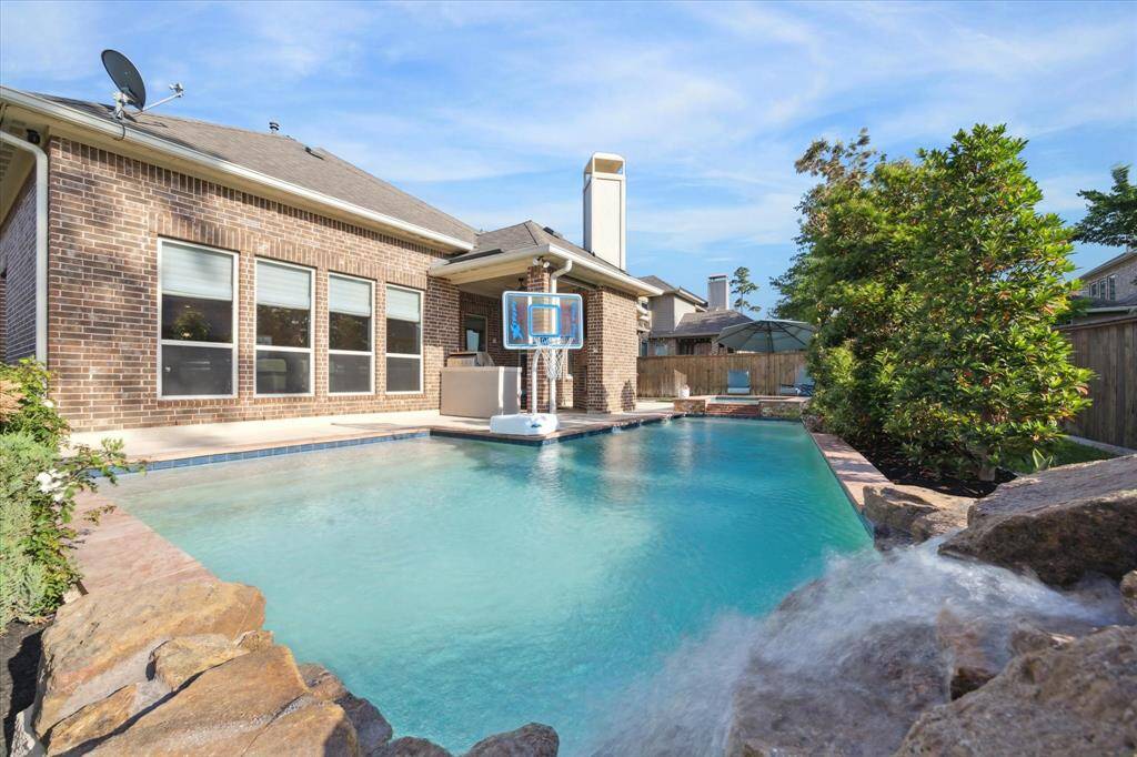 Pool has waterfall feature.
