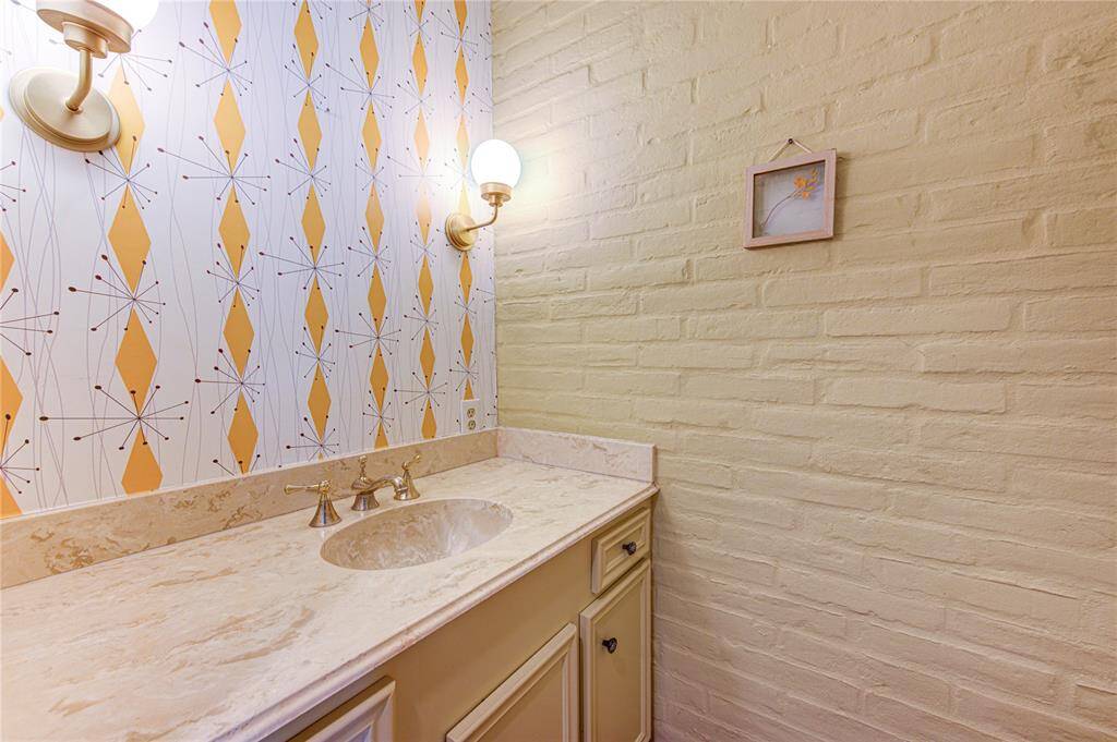 Half bath with tasteful wallpaper and new light fixtures!
