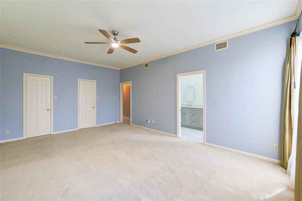 Two walk-in closets on left. En suite bath on right.