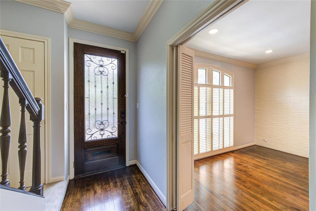 Foyer opening to the formal living area - both with original hardwood flooring.