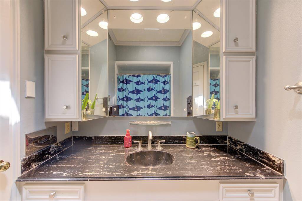 Hall bath with spacious vanity and tub/shower combo.