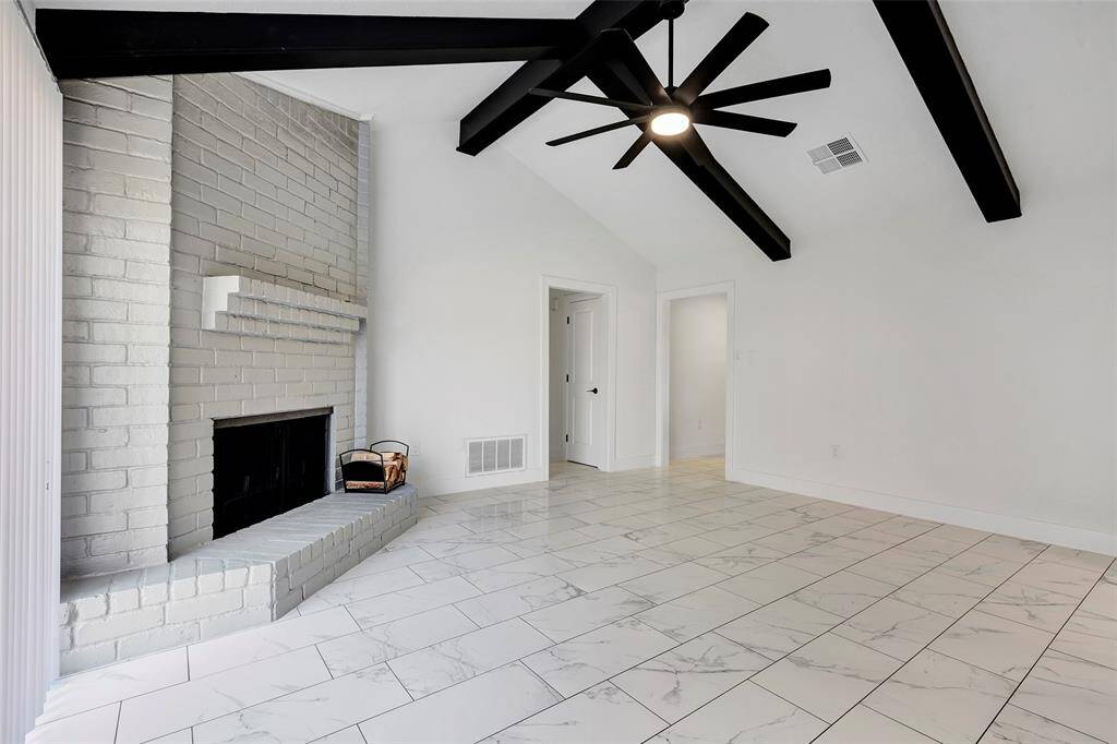 The living room offers easy access to both the kitchen and the bedrooms through conveniently located doors, enhancing the home's flow and functionality.