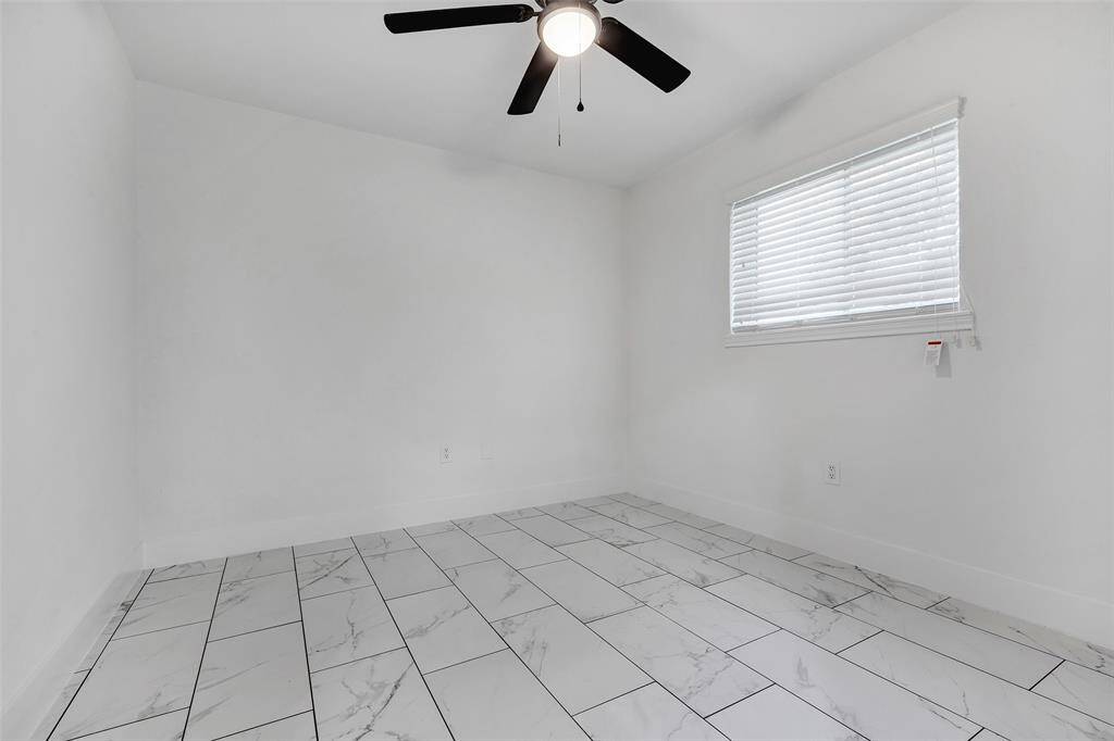 Another secondary bedroom with a tiled floor, offering a clean, versatile space ready for the new owner's personal touch.