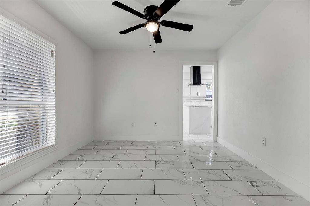 This potential dining room is conveniently connected to the kitchen through the open doorway, creating an ideal flow of the two spaces.