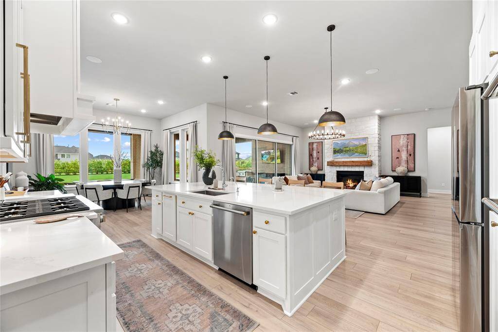 The statement pendant lights above the kitchen island, cast a warm glow over the workspace and add a touch of contemporary elegance.