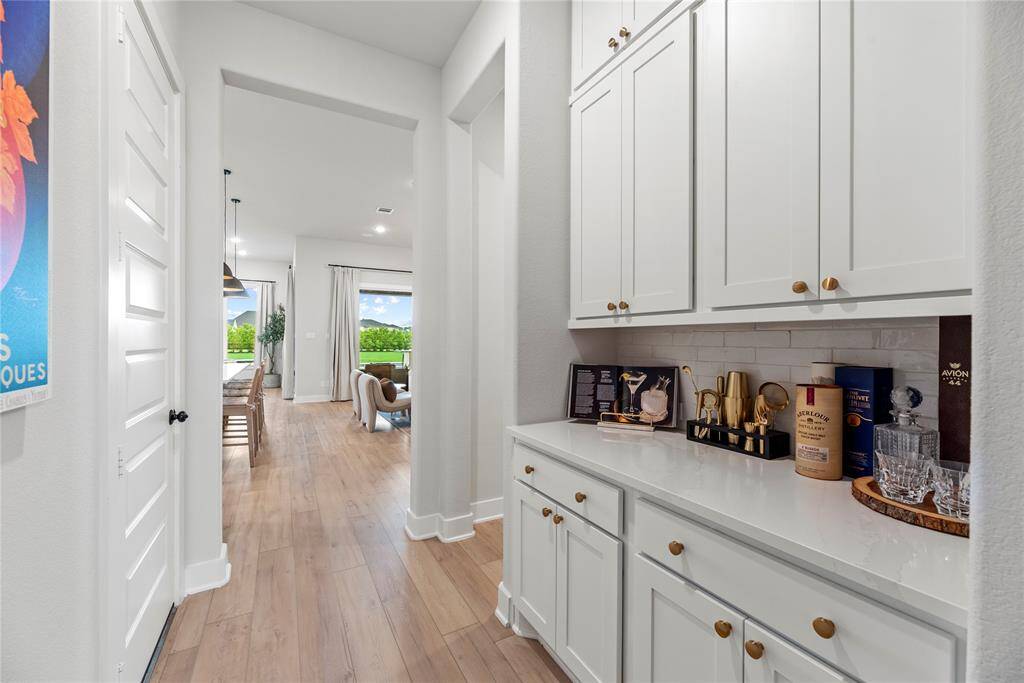 Your very own Butler's Pantry, conveniently nestled between the Kitchen and Dining room, adds a touch of elegance to your hosting experience.