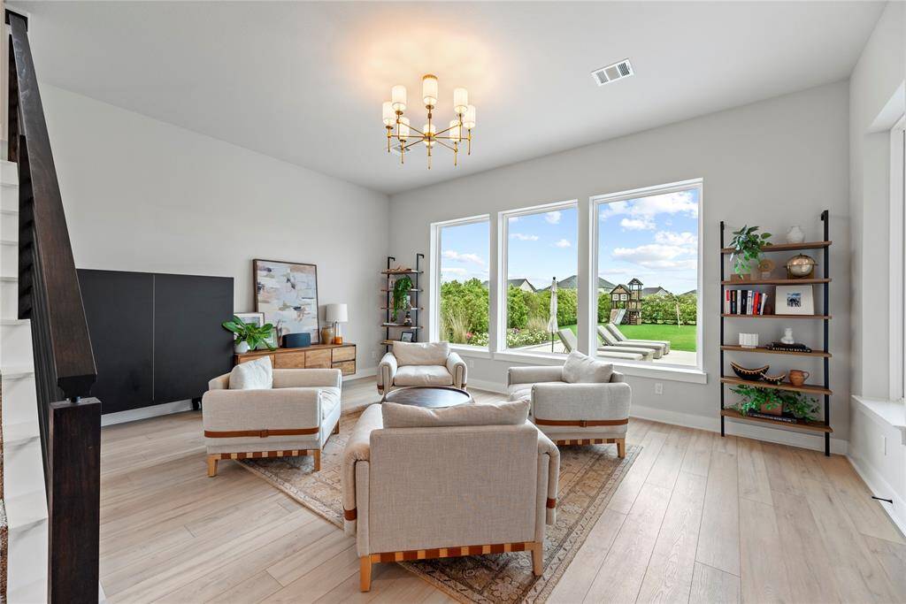 You'll find a stylish living area, perfect for entertaining guests or creating a cozy gathering space with picturesque views of the gorgeous back yard.