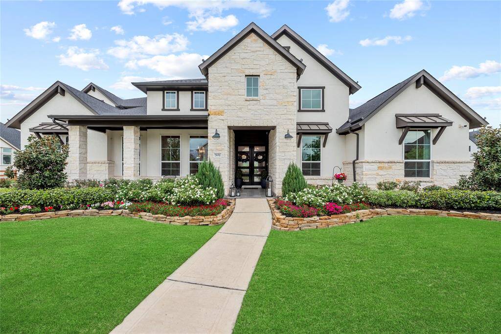 The enchanting blend of stucco and stone exterior radiates timeless charm and refined elegance, instantly elevating the home’s curb appeal. Meticulously designed custom landscaping further accentuates its beauty, making a captivating first impression.
