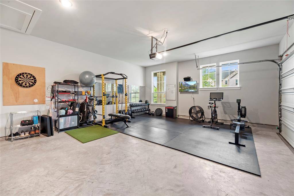 The garage, typically reserved for storing vehicles and tools, has been transformed into a dynamic environment tailored for fitness.