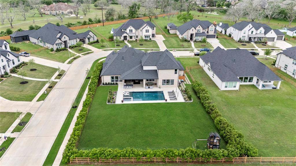 From an aerial perspective at the back of the home, you'll truly appreciate its beauty and elegance. This residence is a stunning testament to what a perfect home can be, offering everything a family could desire and more.