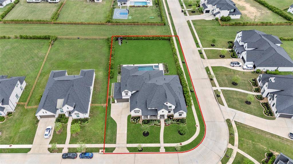 This impressive aerial view showcases the prime location of this home, perfectly positioned on an oversized, corner, cul-de-sac lot.