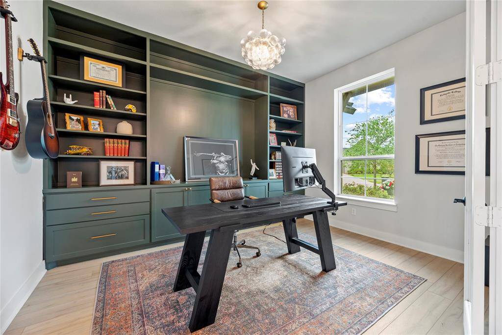 A private study through double glass doors adds a touch of sophistication and privacy to the home. Your home office is sunlit sanctuary meets productivity powerhouse. Custom shelves and designer lighting elevate your workspace.