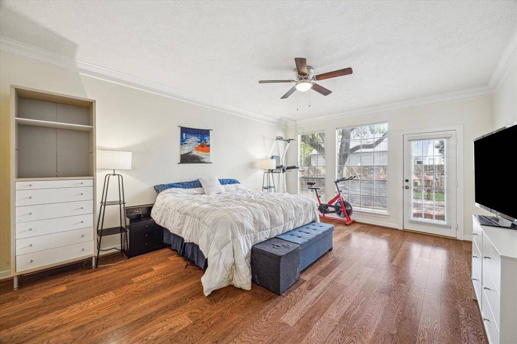 Serene primary bedroom on the first floor, featuring direct access to the backyard.