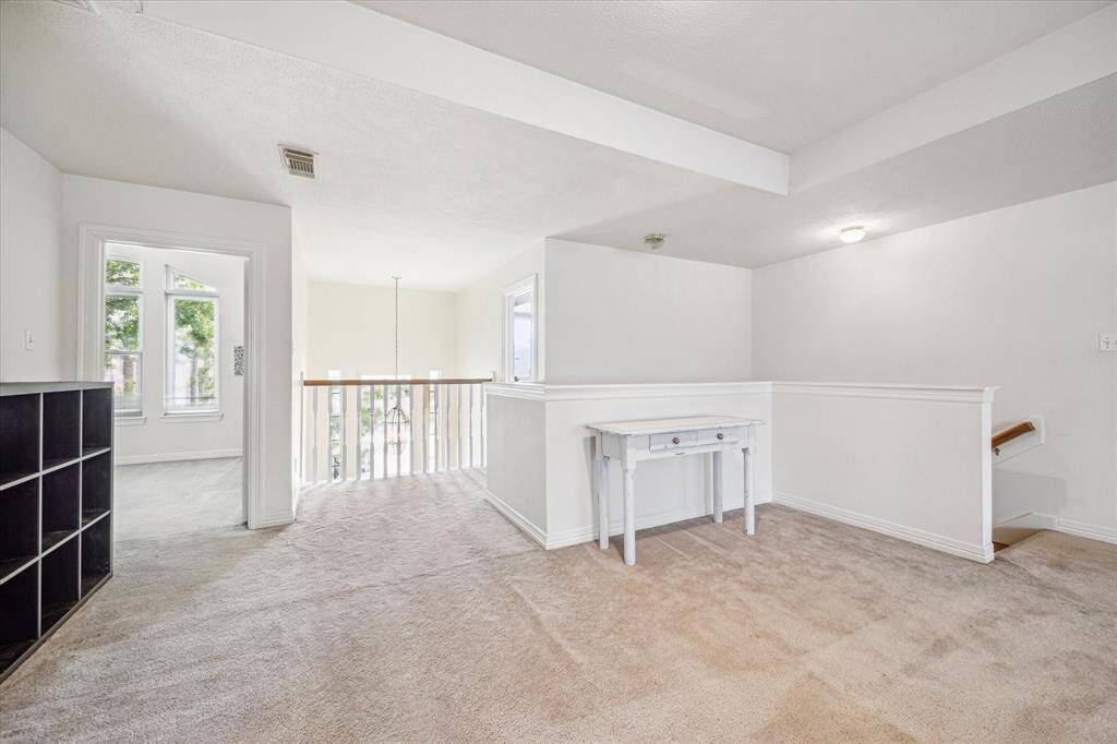 Open landing area on the second floor, offering a versatile space for relaxation or additional living.