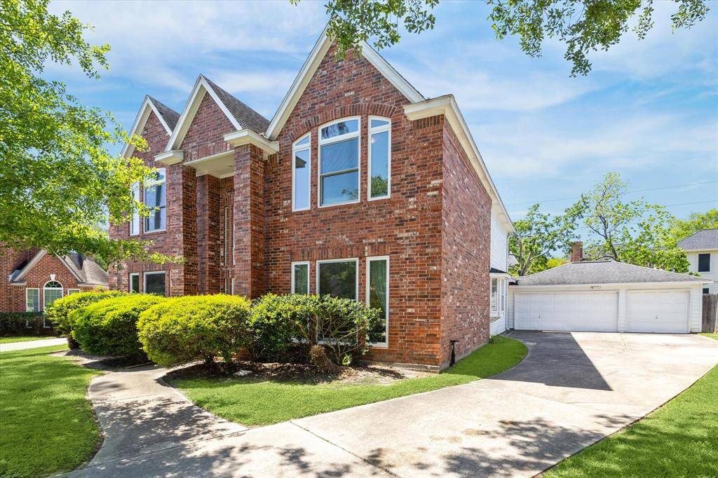 Spacious three-car garage complemented by an extended driveway—offering ample parking.